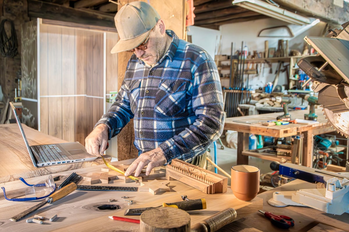 Carpenter measuring wood pieces for joinery with professional carpentry tools